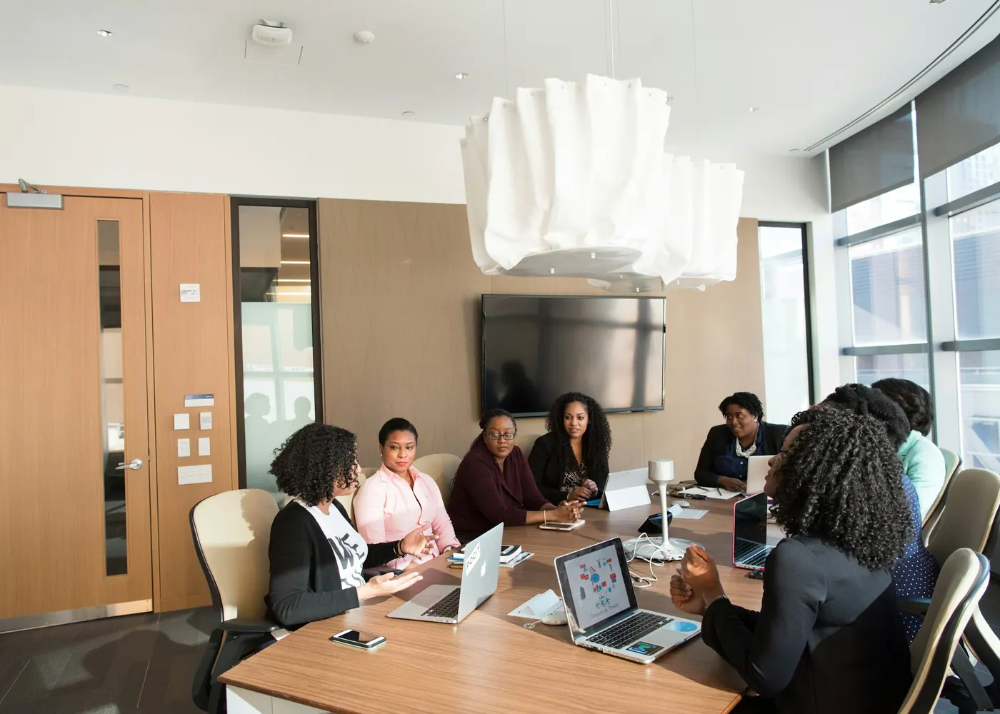 Team members in a working session around a conference table